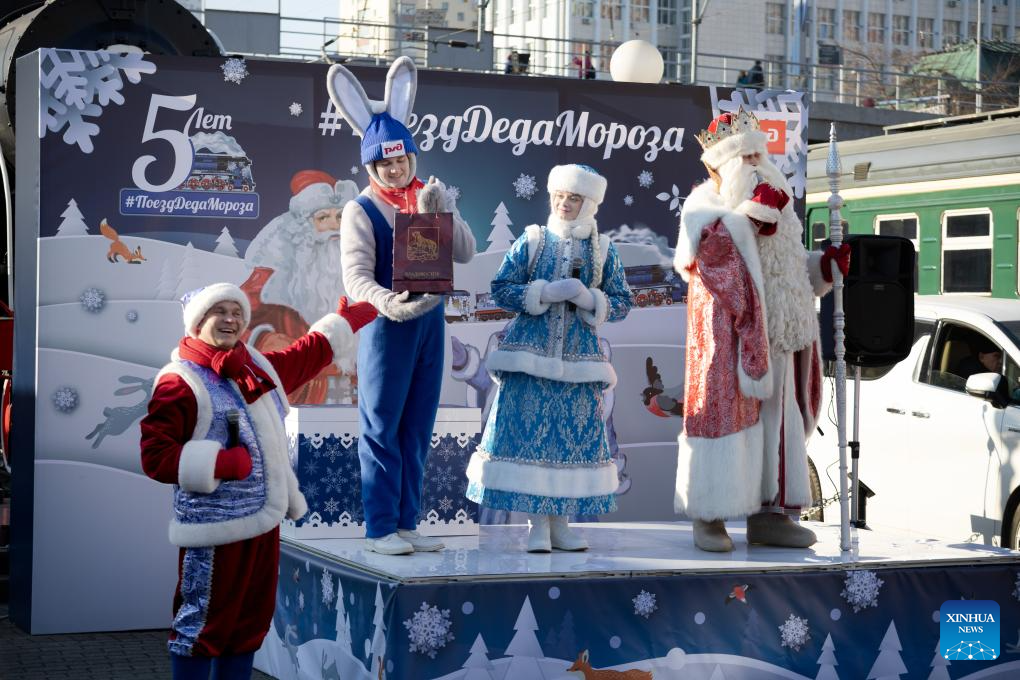 Performers playing the roles of Father Frost and Snow Maiden perform with other actors in Vladivostok, Russia, on Nov. 19, 2025. To celebrate Christmas and the New Year, the Father Frost train departed from Vladivostok on Nov. 19, embarking on a tour across Russia. The train will pass through approximately 70 cities in Russia, eventually arriving in Veliky Ustyugh, the hometown of Father Frost. (Photo by Andrey Matveenko/Xinhua)