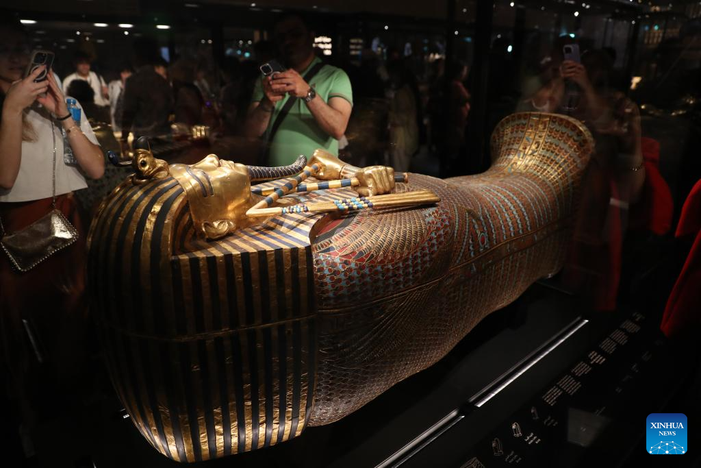 Tourists view a gilded coffin at the King Tutankhamun exhibition hall of the Grand Egyptian Museum in Giza, Egypt, on Nov. 4, 2025. The Grand Egyptian Museum (GEM) , the world's largest museum dedicated to a single civilization, opened to the public on Tuesday. (Xinhua/Sui Xiankai)