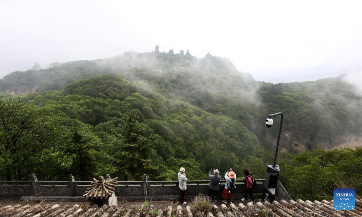 People visit the Kongtong Mountain in Pingliang City, northwest China's Gansu Province, July 11, 2025.

Pingliang in Gansu Province is a key node in the Loess Plateau-Sichuan-Yunnan Ecological barrier and a major ecological zone for soil and water conservation in the hilly areas. The city has transformed traditional industries like the coal-chemical sector and developed eco-friendly projects such as solar and wind power. The forest and grassland coverage of Pingliang has reached 46.07 percent, and it has been recognized as one of the first Chinese national ecological civilization demonstration zones. (Photo by Wu Xihui/Xinhua)
