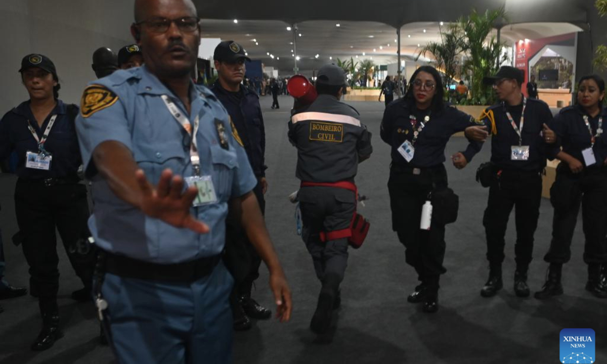 Security personnel control access inside the venue of the 30th United Nations Climate Change Conference (COP30) after a fire broke out in Belem, Para state, Brazil, Nov. 20, 2025. A fire broke out on Thursday in a pavilion at the ongoing 30th UN Climate Change Conference in the Brazilian city of Belem, prompting evacuations by the fire department, according to local authorities. (Photo by Lucio Tavora/Xinhua)