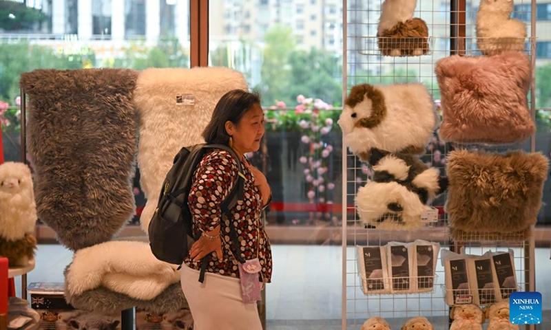 A woman selects products at the CIIE Bazaar City Arena in east China's Shanghai, Nov. 1, 2025. The 8th China International Import Expo (CIIE) is scheduled to take place here from Nov. 5 to 10. (Photo: Xinhua)