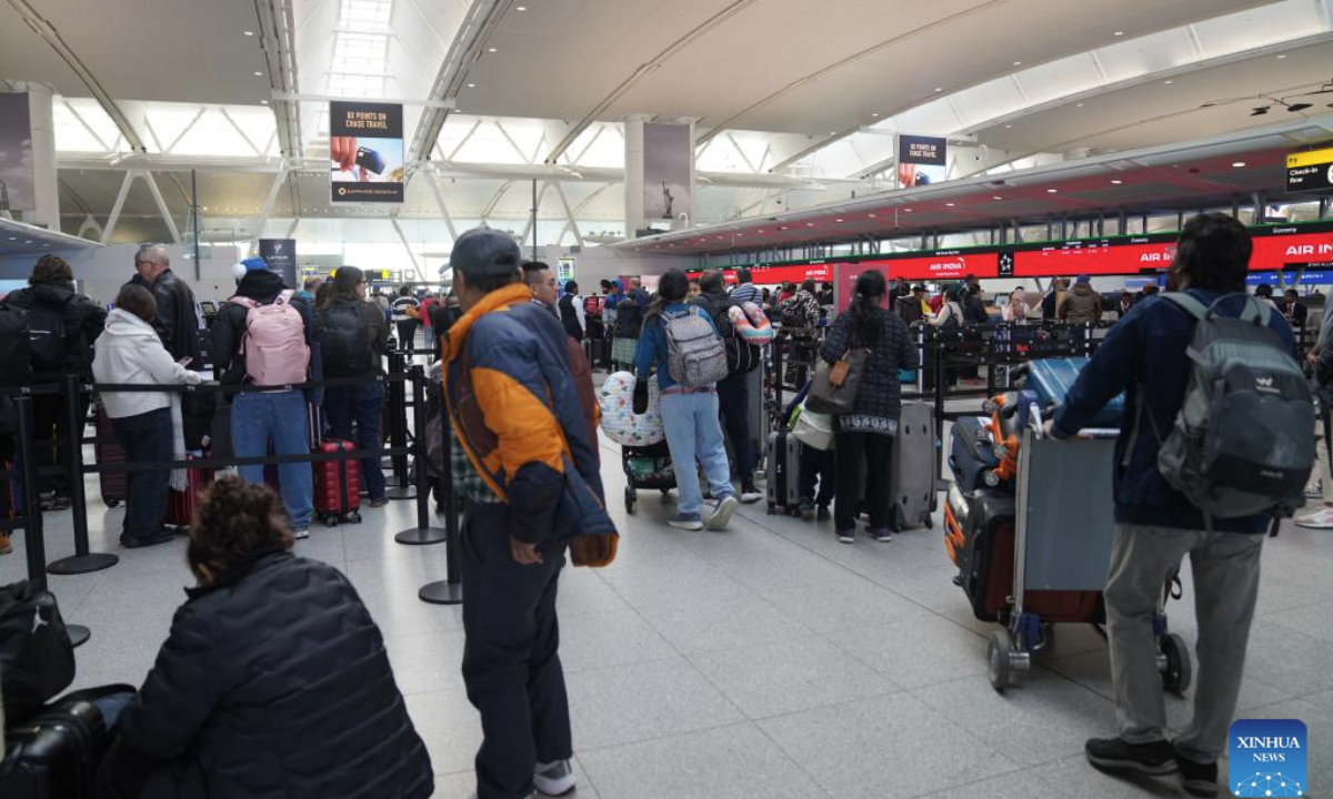 Travellers are seen at the check-in area at John F. Kennedy International Airport (JFK) in New York City, the United States, Nov. 5, 2025. As the two parties remained locked in a war of words, the impact of the record-breaking shutdown continued to spread, dealing a heavy blow to multiple areas affecting people's daily lives, including aviation safety and food assistance programs. Data from the U.S. flight-tracking website FlightAware show that thousands of flights nationwide are experiencing delays each day. (Xinhua/Zhang Fengguo)
