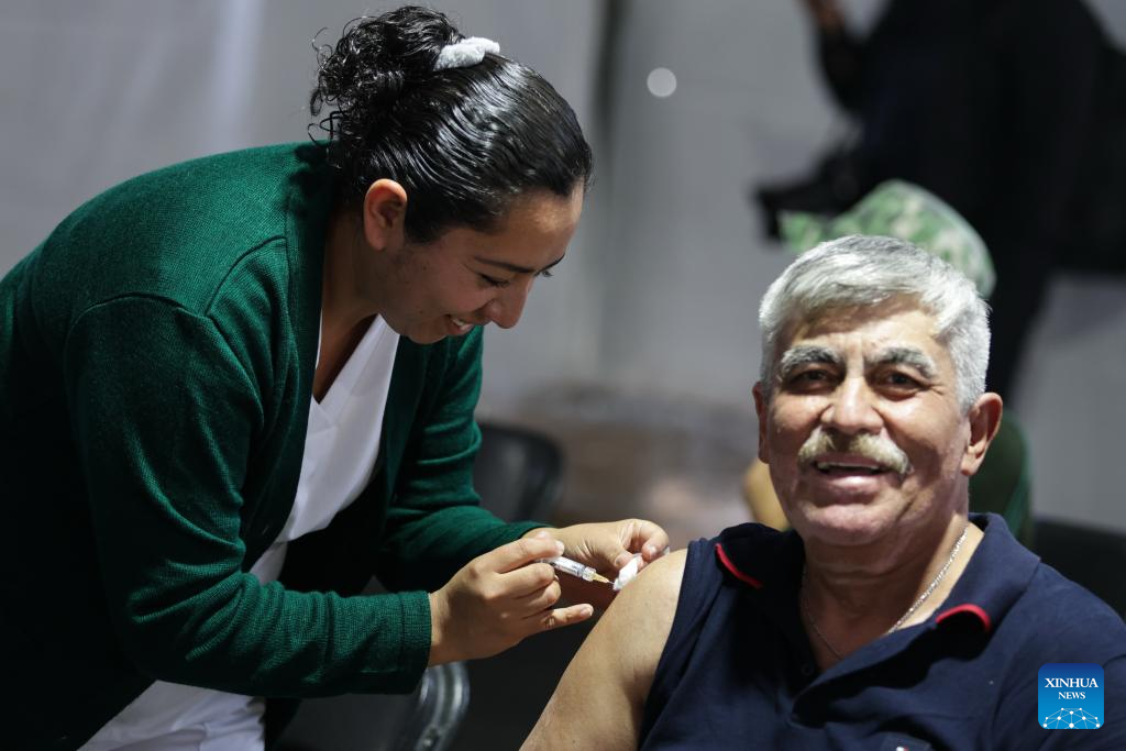 A health worker administers a vaccine to a man at a vaccination center in Mexico City, capital of Mexico, Nov. 12, 2025. Mexico City has set up a vaccination center offering influenza, COVID-19, pneumococcal and measles vaccines to the public as part of efforts to improve community immunization coverage during the winter season. (Photo by Francisco Canedo/Xinhua)