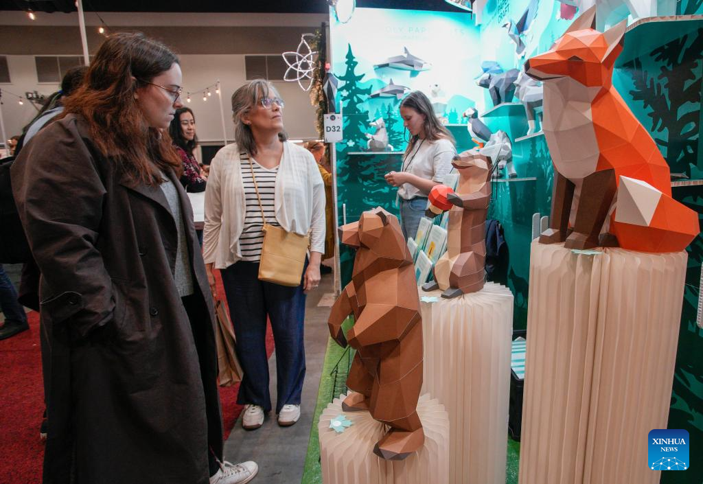 People view paper sculptures at the 2025 edition of the Circle Craft Holiday Market in Vancouver, British Columbia, Canada, Nov. 11, 2025. The 2025 edition of the Circle Craft Holiday Market kicked off here on Tuesday and runs until Nov. 16. (Photo by Liang Sen/Xinhua)