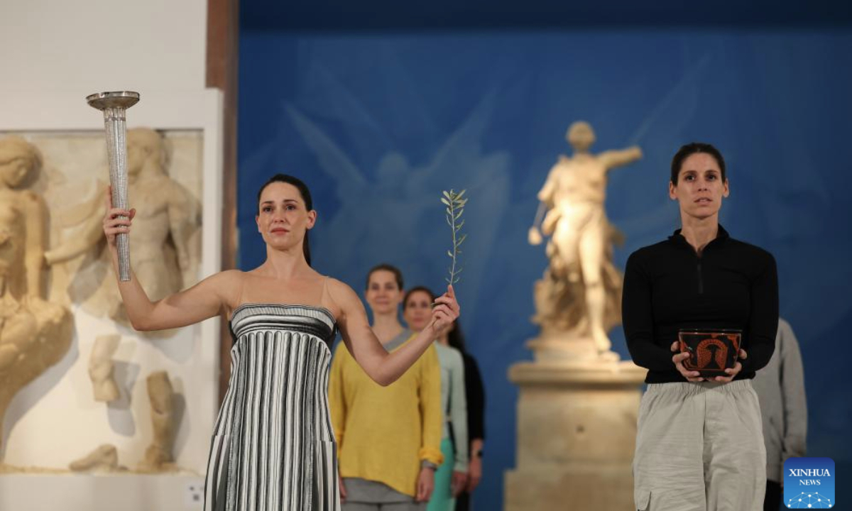 Actress Mary Mina (L), in the role of an ancient Greek High Priestess, performs during the rehearsal of the Olympic flame lighting ceremony for the Milan-Cortina 2026 Winter Olympic Games in Ancient Olympia, Greece, on Nov. 25, 2025. (Xinhua/Li Jing)
