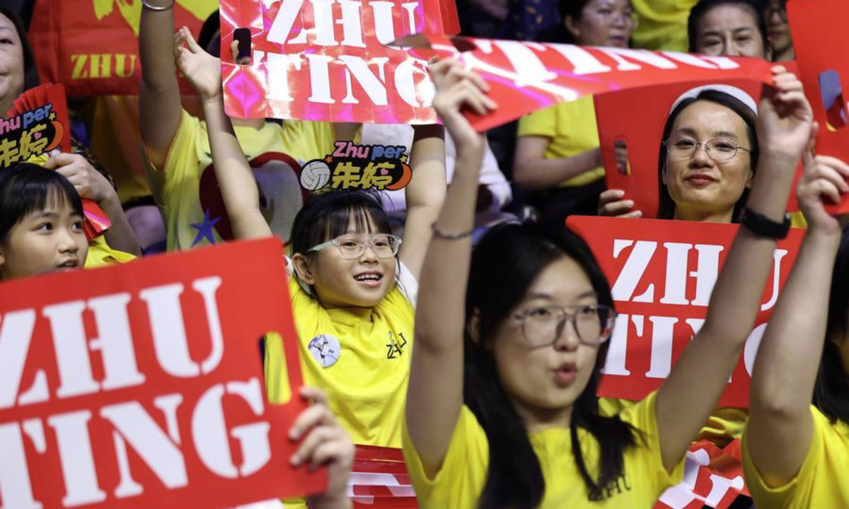 Fans cheer for Zhu Ting of Henan during women's volleyball group A match between Henan and Beijing at China's 15th National Games in Macao, south China, Nov. 12, 2025. (Xinhua/Chen Bin)