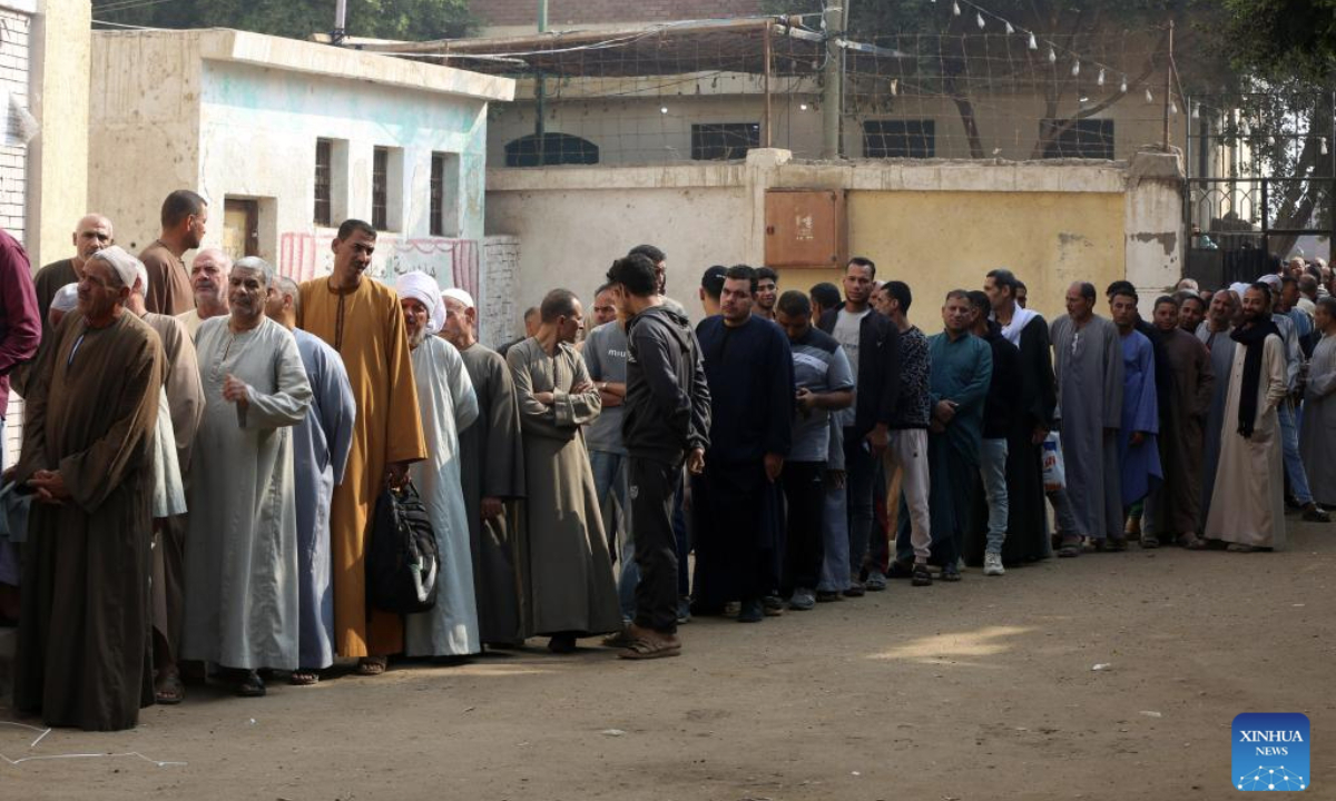 Egyptians queue up to vote at a polling station during the first phase of House of Representatives elections in Giza, Egypt, Nov. 10, 2025. Voting began on Monday in the first phase of Egypt's 2025 House of Representatives elections, which will last till Tuesday. (Photo by Mohamed Asad/Xinhua)