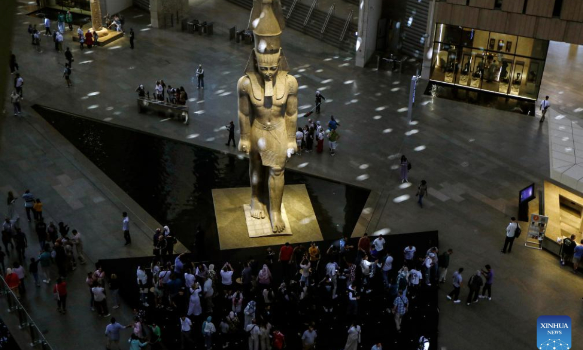 Tourists stand around the colossus of ancient Egyptian pharaoh Ramses II at the Grand Egyptian Museum in Giza, Egypt, on Nov. 4, 2025. The Grand Egyptian Museum (GEM) , the world's largest museum dedicated to a single civilization, opened to the public on Tuesday. (Xinhua/Ahmed Gomaa)