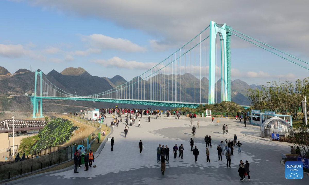 This drone photo taken on Nov. 6, 2025 shows tourists viewing the Huajiang Grand Canyon Bridge at the nearby Yundu service area in southwest China's Guizhou Province. The Huajiang Grand Canyon Bridge, soaring 625 meters above the Beipan River in Guizhou's mountainous terrain, is the world's highest bridge. The nearby Yundu service area features a comprehensive complex that integrates bridge viewing, sports experiences and other tourism services. (Xinhua/Ou Dongqu)