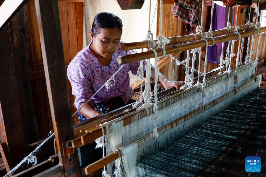 A woman weaves on a traditional loom at a hand-weaving workshop on Inle Lake in Nyaungshwe township, Shan state, Myanmar, Oct. 31, 2025. (Photo: Xinhua)
