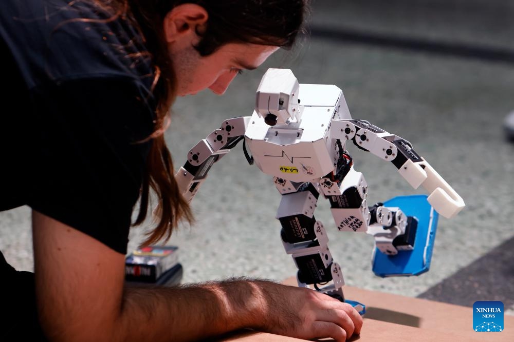 A participant prepares his robot for a contest during the 4th edition of the Robofest, a technology festival, at the Politehnica University of Bucharest in Bucharest, Romania, Nov. 1, 2025. The three-day festival including the 16th edition of the Robochallenge is held here from Oct. 31 to Nov. 2. (Photo: Xinhua)