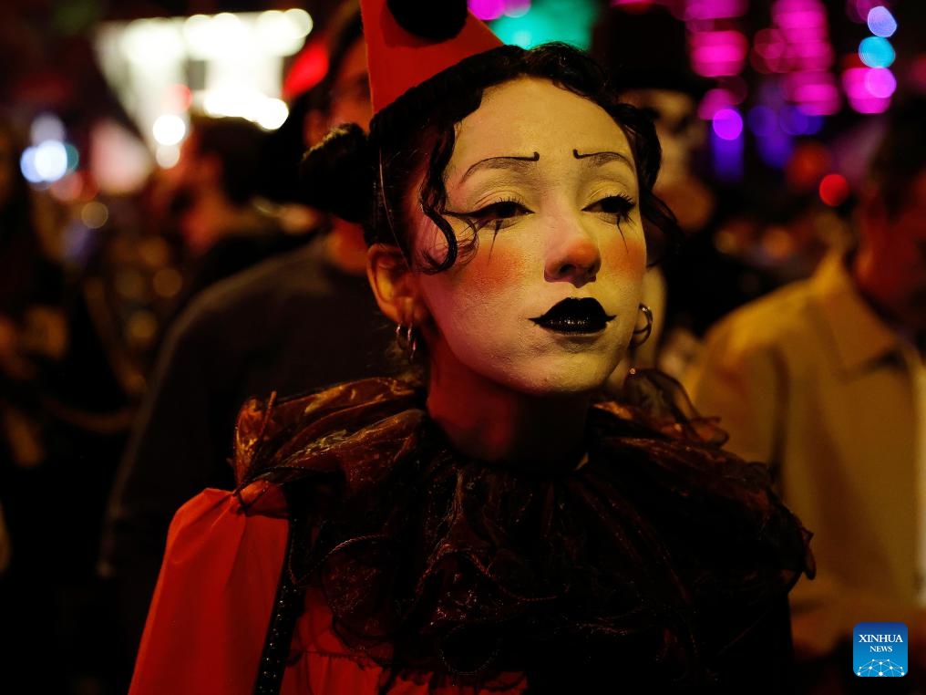 A participant with facial makeup is pictured on Santa Monica Boulevard during the Halloween Carnival in West Hollywood, Los Angeles, California, the United States, on Oct. 31, 2025.(Photo: Xinhua)