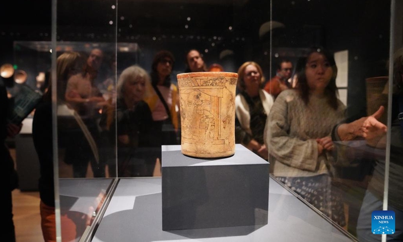 People look at a drinking cup from late classic period at the Princeton University Art Museum in New Jersey, the United States, on Nov. 1, 2025. After 13 years of design and construction, the new art museum of Princeton University reopened its doors to the general public with a 24-hour party from 5 p.m. Oct. 31, to 5 p.m. Nov. 1. (Photo: Xinhua)