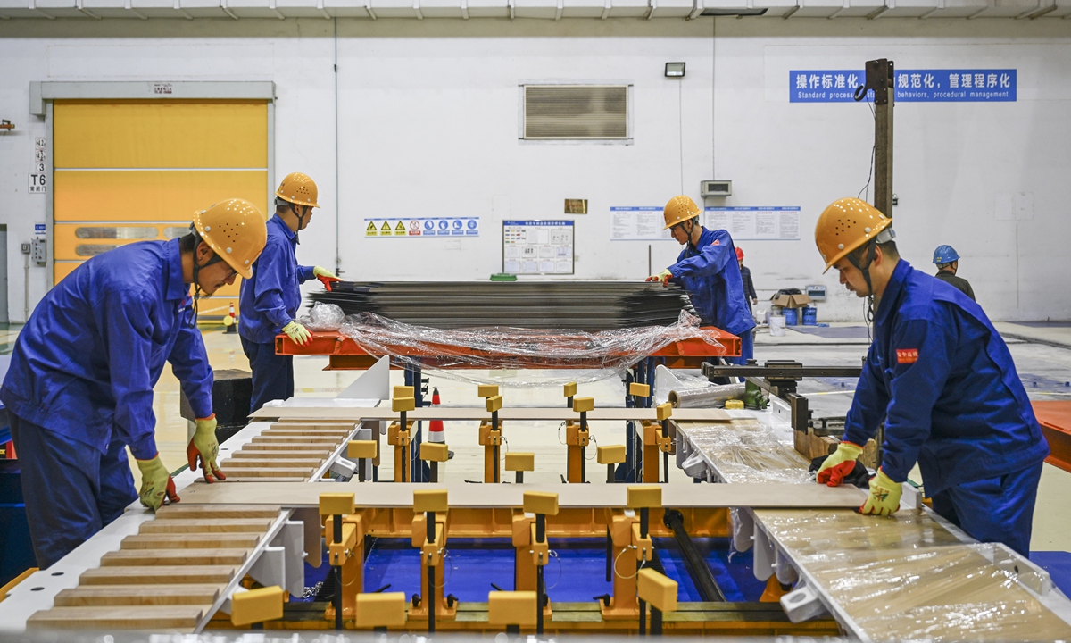 Workers assemble silicon steel sheets for a new-energy transformer at a workshop of a transformer company in Hefei, East China's Anhui Province on November 3, 2025. This year, the company has stayed true to market demands, driven by technological innovation to boost its research and development capabilities for high-end new-energy products, delivering fresh insights to fuel the energy industry's growth. Photo: VCG