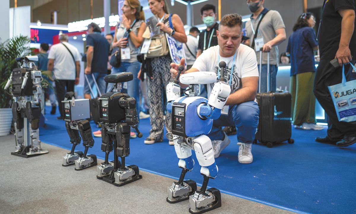A foreign audience checks a humanoid robot at the 138th China Import and Export Fair on October 25, 2025. Photo: VCG