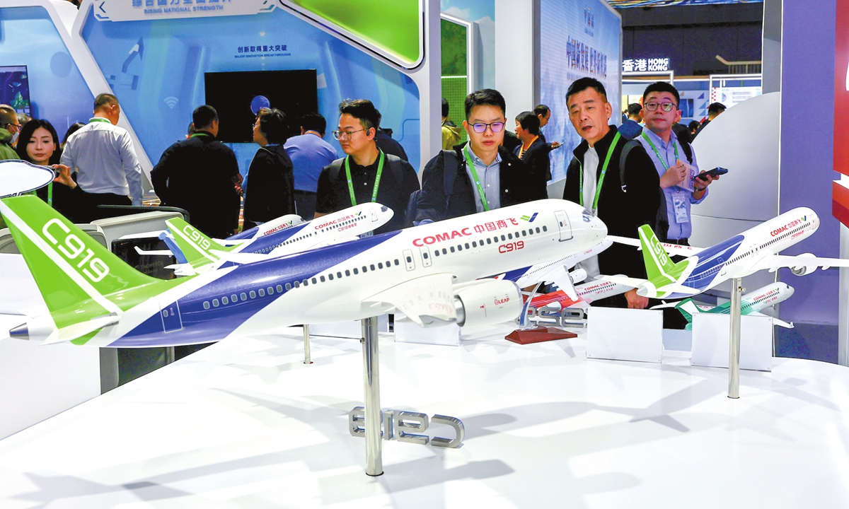 Visitors check models of China's homegrown large aircraft C919 at the 8th China International Import Expo in Shanghai on November 6, 2025. This edition of the event boasts participation from 155 countries, regions and international organizations, with 4,108 overseas exhibitors. Photo: VCG
