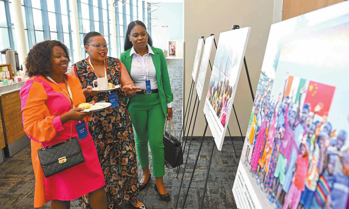 Guests view a photo at the exhibition in Johannesburg, South Africa, on November 5, 2025. Photo: Chen Tao/GT