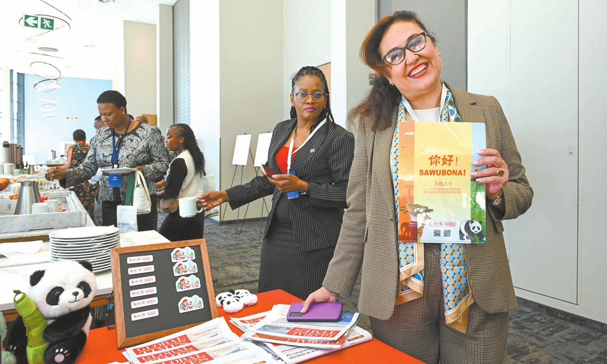 Guests view and pick creative products from the Global Times on display at the photo exhibition held in Johannesburg, South Africa, on November 5, 2025. Photo: Chen Tao/GT