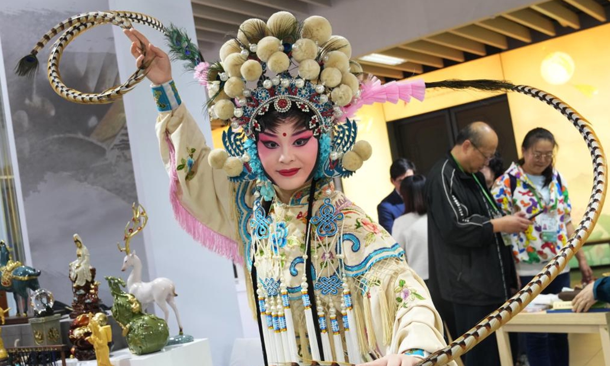 A Sichuan Opera performer prepares for the stage during the eighth China International Import Expo (CIIE) in east China's Shanghai, Nov. 8, 2025. The CIIE is not only a global platform for the trade of goods and services but also a grand event for the exchange of cultures and ideas between China and the world. (Xinhua/Liu Ying)