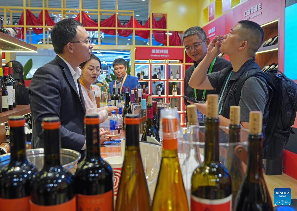 Visitors taste wine at the booth of China's Ningxia Hui Autonomous Region during the eighth China International Import Expo (CIIE) in east China's Shanghai, Nov. 8, 2025. The CIIE is not only a global platform for the trade of goods and services but also a grand event for the exchange of cultures and ideas between China and the world. (Xinhua/Liu Ying)