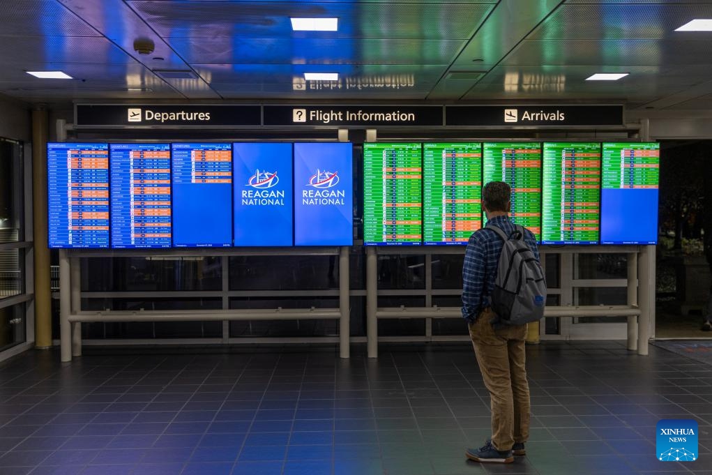 A man checks flight information at Ronald Reagan Washington National Airport in Arlington, Virginia, the United States, Nov. 7, 2025. Over 1,000 U.S. flights were canceled on Friday as a reduction in air traffic took effect amid an air traffic controller staffing shortage during the longest federal government shutdown in U.S. history. (Xinhua/Hu Yousong)