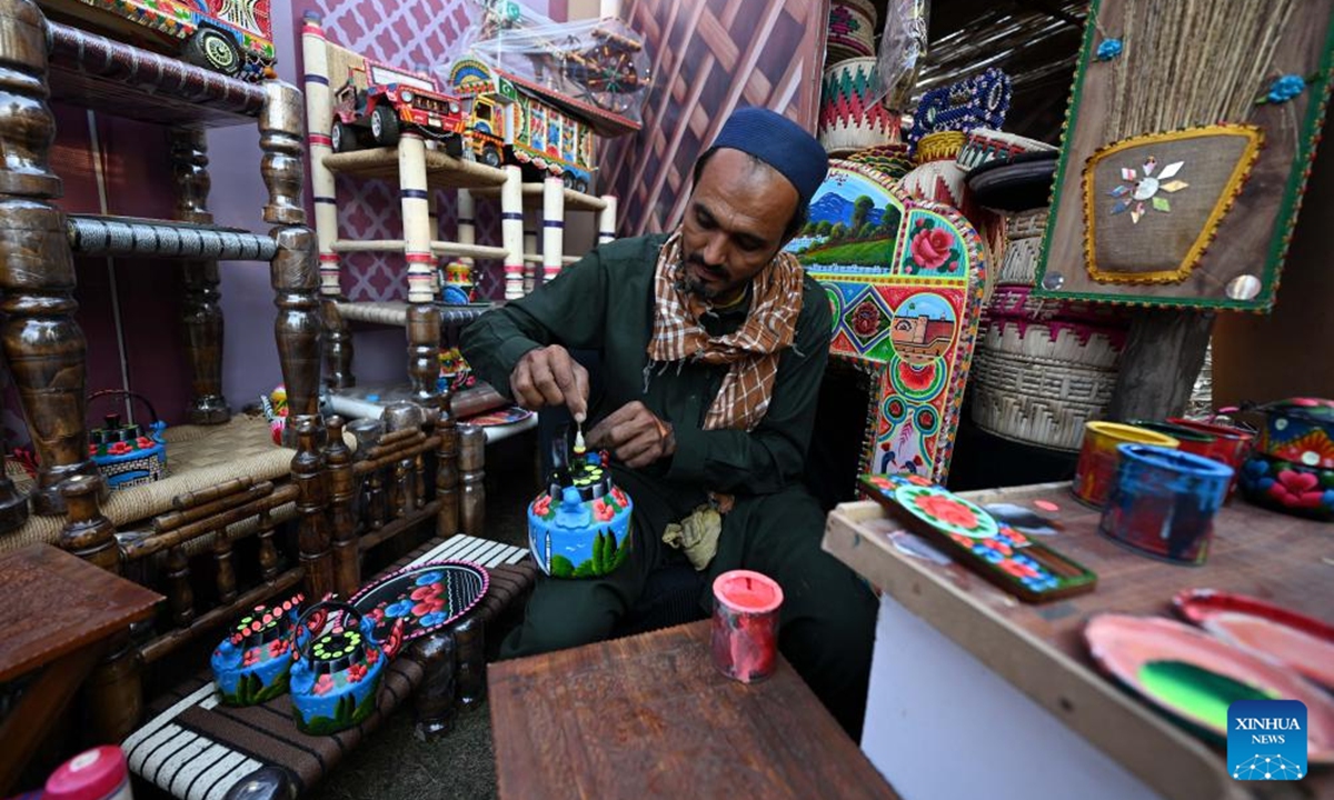An artist decorates a tea-pot during the Lok Mela Festival in Islamabad, capital of Pakistan, Nov. 7, 2025. The annual ten-day folk festival kicked off here on Friday. (Photo by Ahmad Kamal/Xinhua)