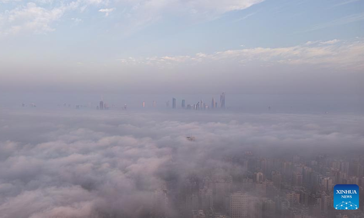 An aerial drone photo taken on Nov. 9, 2025 shows buildings shrouded in fog in Kuwait City, Kuwait. (Photo by Asad/Xinhua)