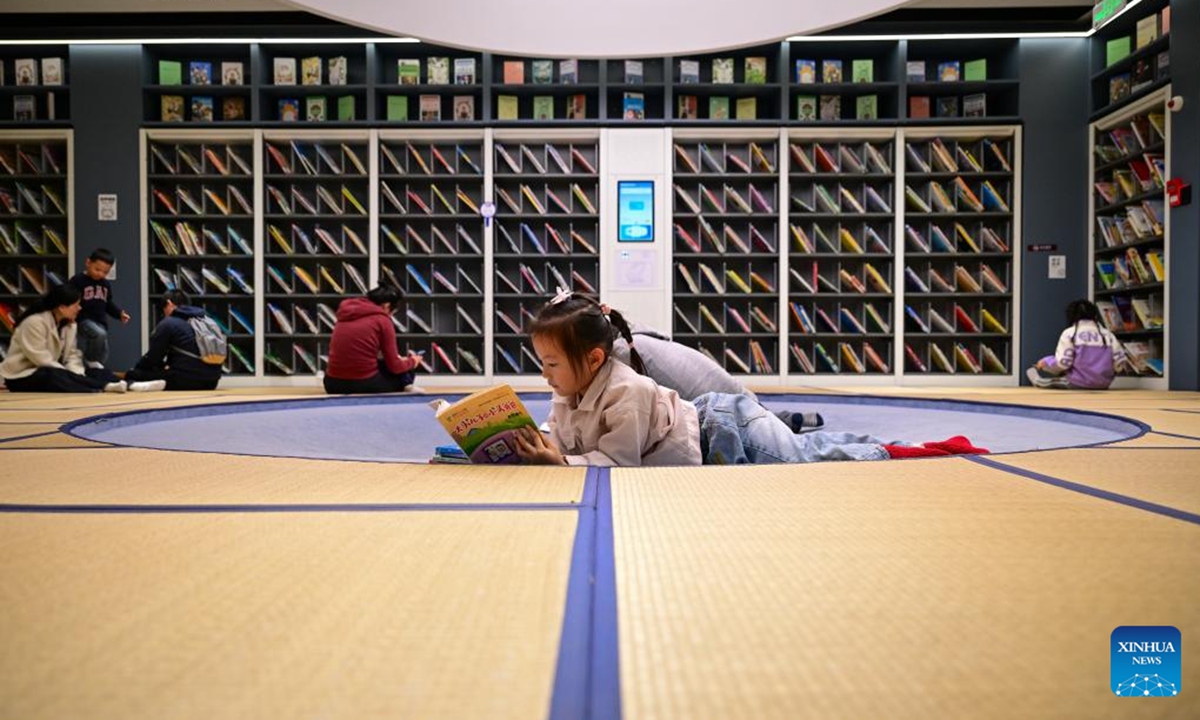 Children read books at a public library in east China's Shanghai, Nov. 9, 2025. In recent years, Shanghai has focused on optimizing historical and cultural districts, developing urban cultural lifestyle areas, enriching citizens' cultural lives, and promoting the deep integration of culture and tourism. (Xinhua/Cai Xiangxin)