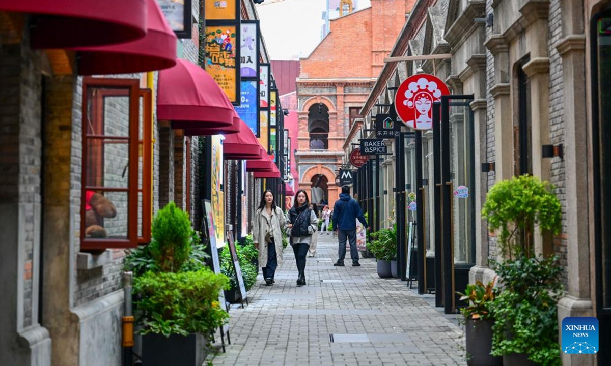 People visit a fashion landmark district in east China's Shanghai, Nov. 9, 2025. In recent years, Shanghai has focused on optimizing historical and cultural districts, developing urban cultural lifestyle areas, enriching citizens' cultural lives, and promoting the deep integration of culture and tourism. (Xinhua/Cai Xiangxin)