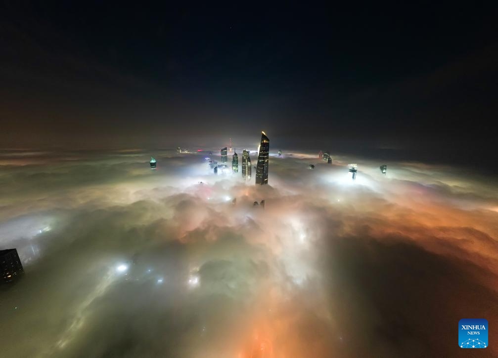 An aerial drone photo taken on Nov. 9, 2025 shows buildings shrouded in fog in Kuwait City, Kuwait. (Photo by Asad/Xinhua)