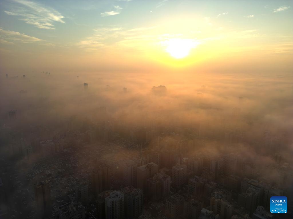 An aerial drone photo taken on Nov. 9, 2025 shows buildings shrouded in fog in Kuwait City, Kuwait. (Photo by Asad/Xinhua)