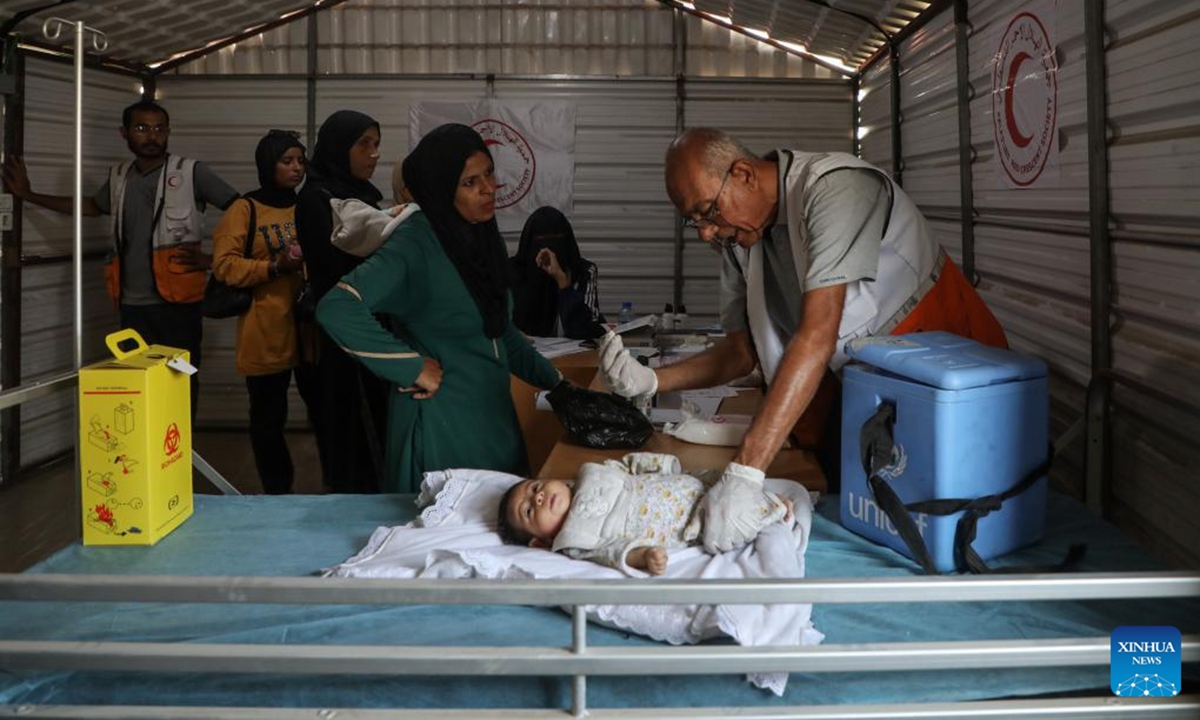 A Palestinian child receives vaccination at a field hospital in central Gaza City, on Nov. 9, 2025. (Photo by Rizek Abdeljawad/Xinhua)