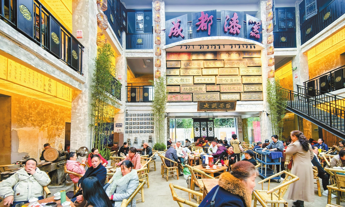 Visitors enjoy tea at a teahouse converted from a lacquerware factory in Chengdu, Southwest China's Sichuan Province, on November 12, 2025. Centered around tea culture, the venue retains distinctive elements of Chengdu lacquerware and offers tea, food, performances and lacquerware shopping.
