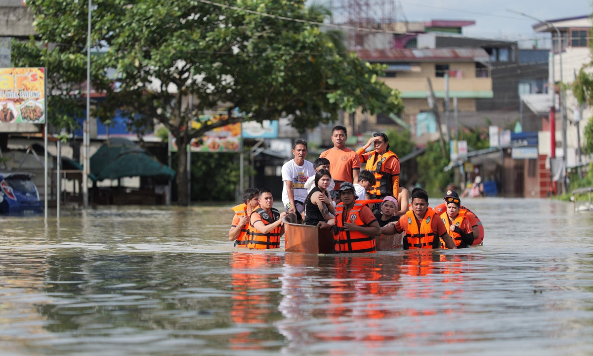 Rescuers pull an inflatable boat loaded with residents during a forced evacuation at a village in Tuguegarao City, Philippines on November 11, 2025, as flood waters continue to inundate homes due to heavy rains brought about by Super Typhoon Fung-wong. Photo: VCG