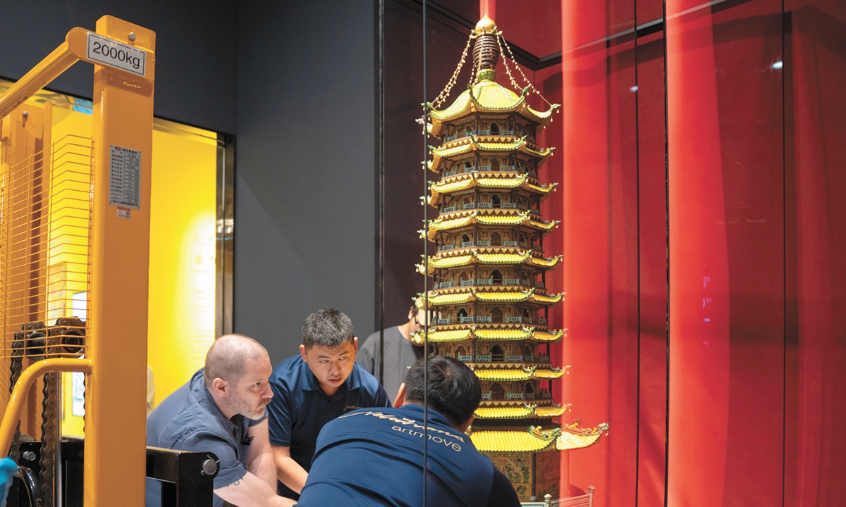 Staff members carry the wooden model of Nanjing's lost Glazed Pagoda into the Great Bao'en Temple Ruins Museum in Nanjing on September 19. Photo: Courtesy of the Nanjing's Great Bao'en Temple Ruins Museum