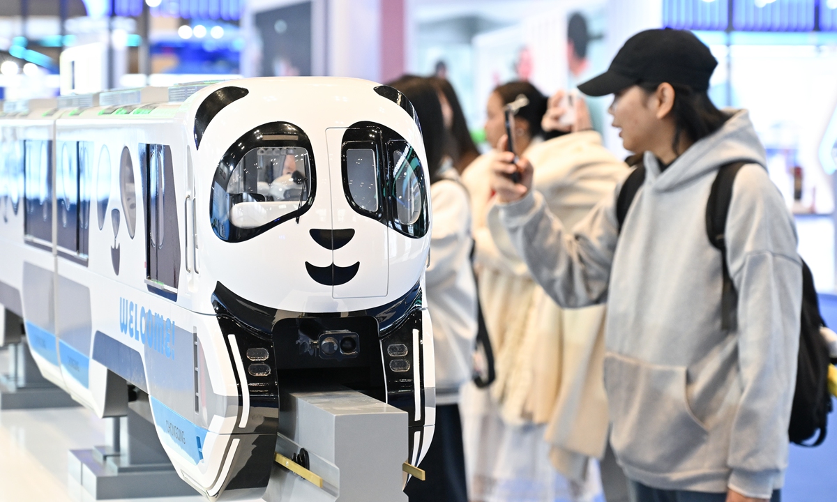 A giant panda-themed straddle-type monorail train model is on display at the New Land-Sea Corridor International Logistics Expo in Chongqing on November 13, 2025, attracting visitors. Photo: VCG