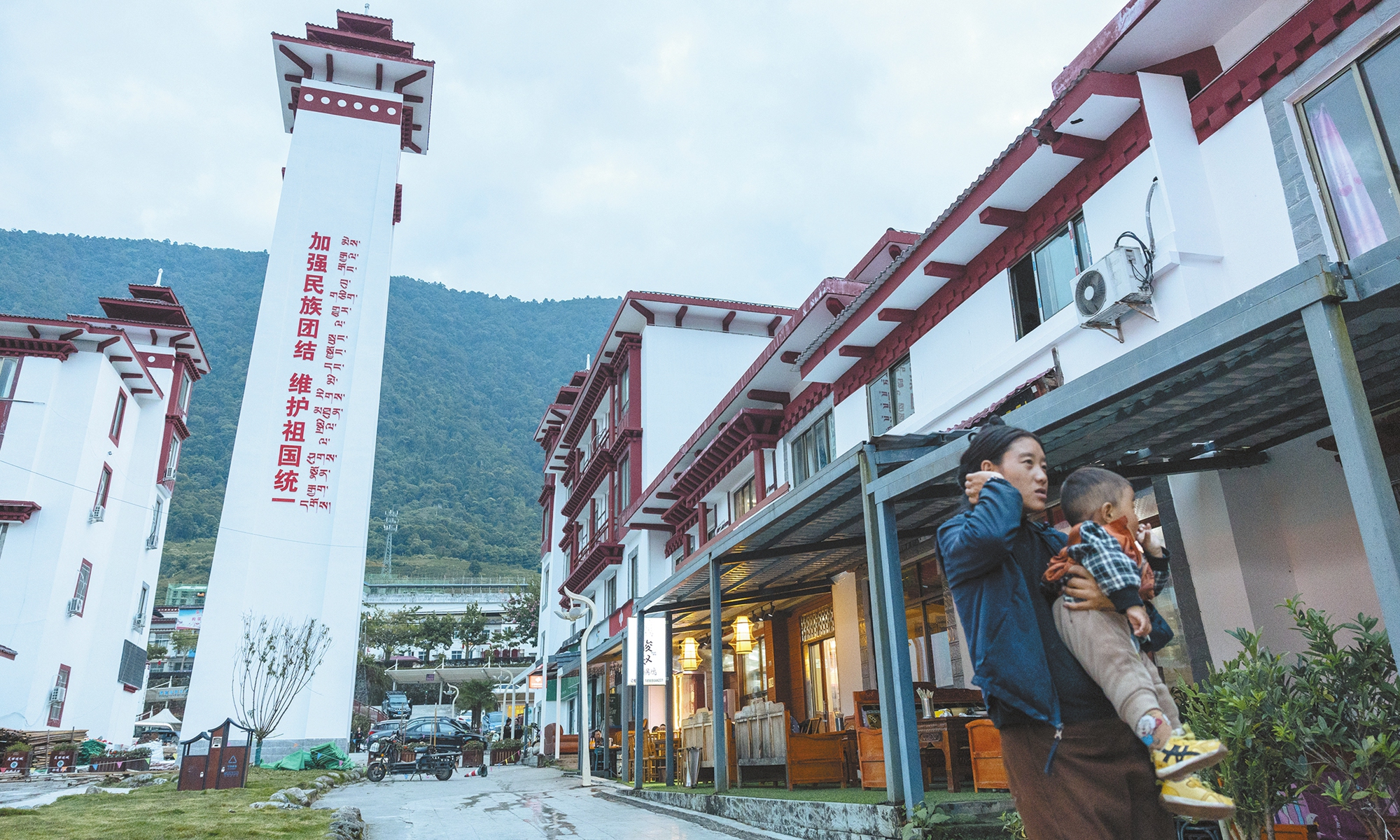 Shops and homes line a street in Medog county center in October 2025.