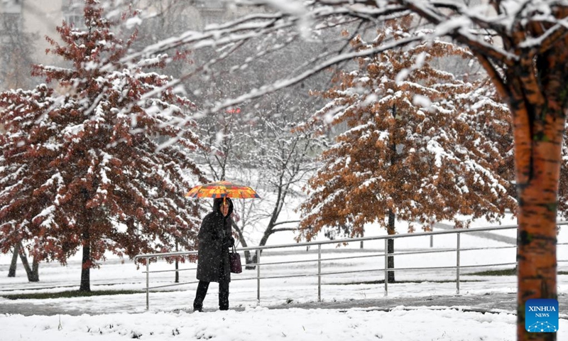 A woman walks in snow in Moscow, Russia, on Nov. 15, 2025. Moscow on Friday saw its first snowfall since the beginning of winter this year. Photo: Xinhua