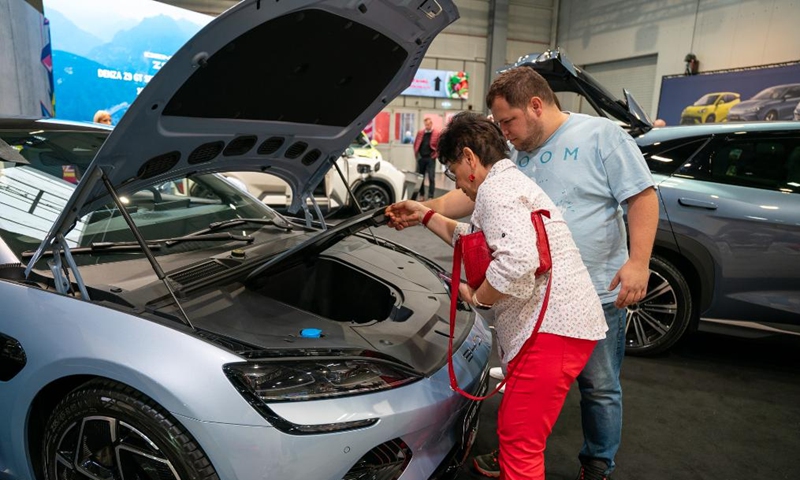 People learn about a BYD vehicle at the 7th e-SALON in Prague, the Czech Republic, Nov. 14, 2025. The e-SALON, a trade fair for passenger and commercial vehicles with alternative propulsion, opened to public on Friday and will last until Sunday. Photo: Xinhua