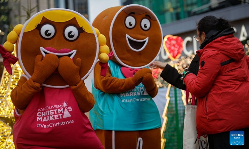 Performers dressed as gingerbread men interact with visitors at the Vancouver Christmas Market in Vancouver, British Columbia, Canada, Nov. 14, 2025. The annual festive event features more than 110 wooden huts offering various handicrafts, traditional European food, drink, and souvenirs, along with live performances. This year's market opened here on Thursday and will run until Dec. 24. Photo: Xinhua