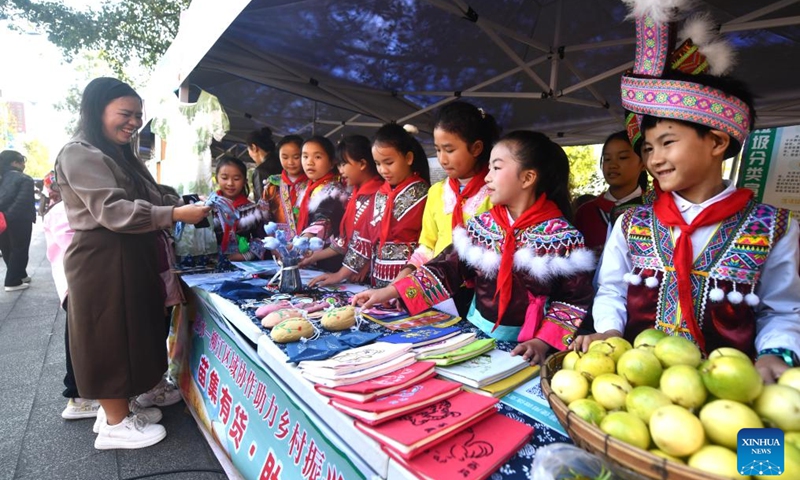 Students attend an agricultural fair in Rongshui Miao Autonomous County, south China's Guangxi Zhuang Autonomous Region, Nov. 15, 2025. A Miao town community of Rongshui County held this fair to showcase and promote agricultural specialties and intangible cultural heritage from neighboring townships. Photo: Xinhua