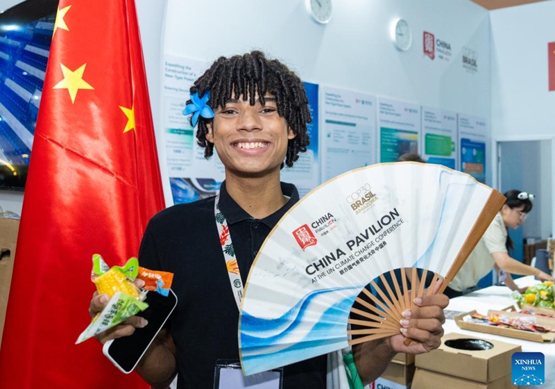 A guest displays a folding fan at the China Pavilion during the 30th United Nations climate change conference in Belem, Brazil, Nov. 12, 2025. The 30th United Nations climate change conference, commonly known as COP30, opened Monday in Belem, Brazil. Displays of Chinese cultural products, green technologies, and innovations attracted attention of the attendees during the conference. Photo: Xinhua