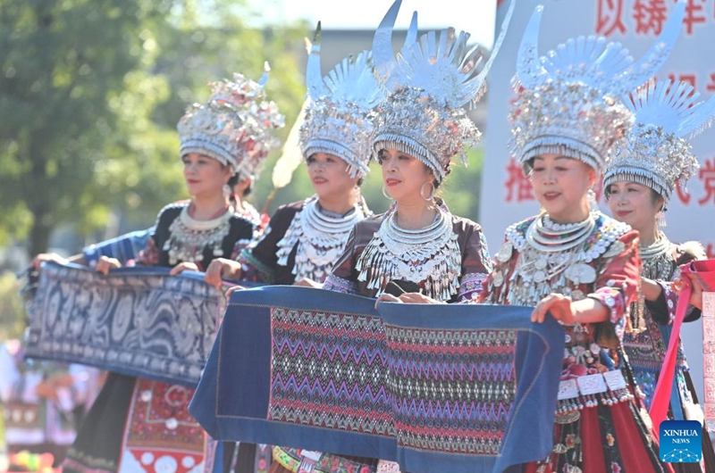 Actresses display brocades of Miao ethnic group at an agricultural fair in Rongshui Miao Autonomous County, south China's Guangxi Zhuang Autonomous Region, Nov. 15, 2025. A Miao town community of Rongshui County held this fair to showcase and promote agricultural specialties and intangible cultural heritage from neighboring townships. Photo: Xinhua
