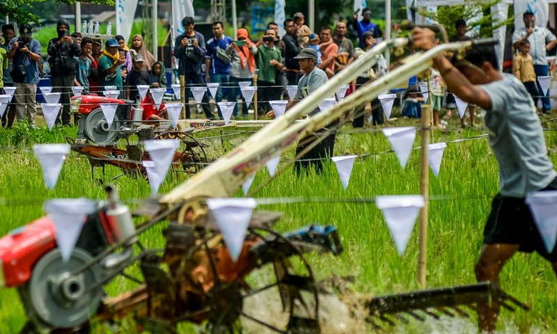 Farmers participate in a rice field tractors racing on a muddy rice field in Kebonagung village, Bantul regency, Yogyakarta, Indonesia, Nov. 16, 2025. (Photo by Agung Supriyanto/Xinhua)
