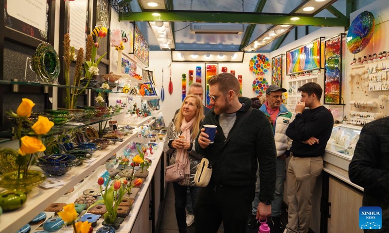 People shop at a holiday market of the Winter Village at Bryant Park in New York, the United States, on Nov. 15, 2025. Featuring a holiday market, a skating rink and a food hall, the Winter Village is a popular winter holiday destination at Bryant Park. Photo: Xinhua
