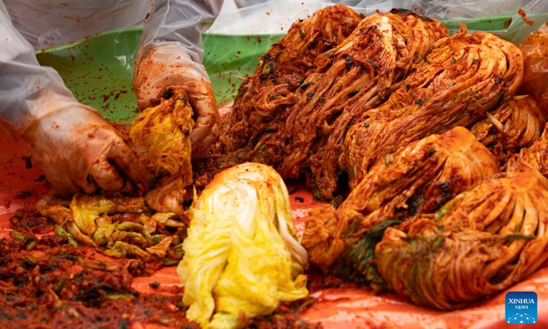 People make Kimchi, pickled vegetable, for a sharing event at the Jogyesa temple in Seoul, South Korea, Nov. 16, 2025. Local people made Kimchi, which will be shared with their neighbours in need, during a sharing event held here on Sunday. Photo: Xinhua