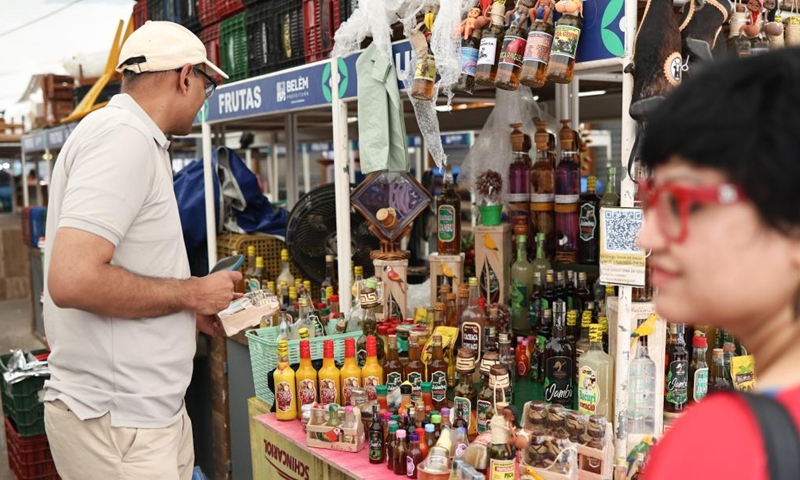 Visitors shop for souvenirs at the Ver-o-Peso Market in Belem, Brazil, Nov. 16, 2025. (Photo by Claudia Martini/Xinhua)