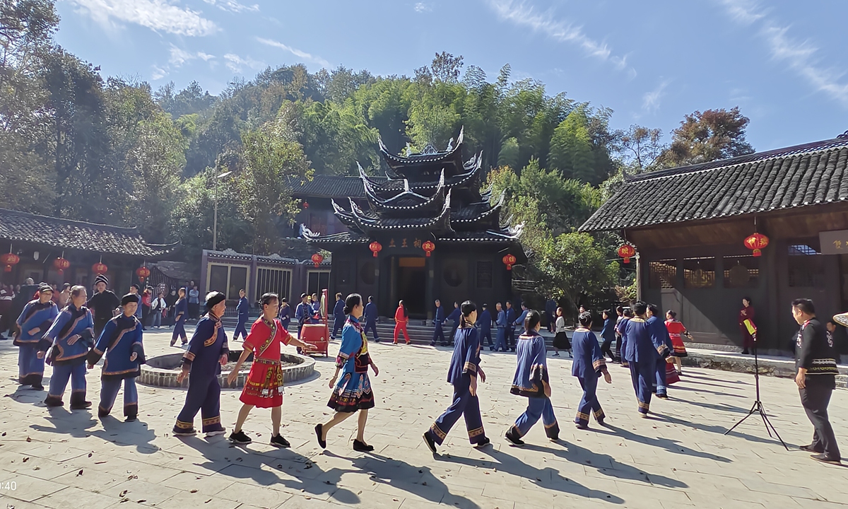People perform the traditional hand-waving dace at the Baishou Hall, Shuangfeng Village in Central China's Hunan Province.