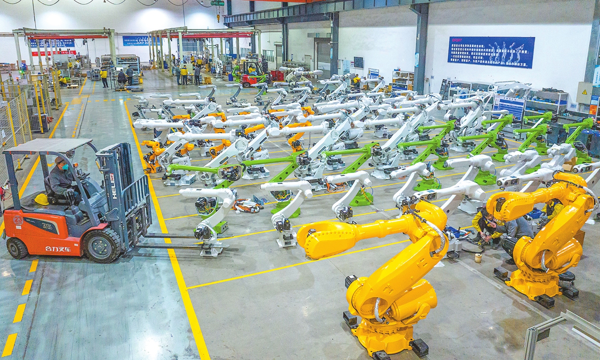 A worker assembles intelligent industrial robots at the factory of Chinese industrial robot producer Openmind (Wuhu) Intelligent Robot Co in Jiujiang Economic Development Zone, Wuhu, East China's Anhui Province, on November 20, 2025. Photo: VCG