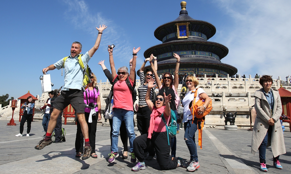 Foreign tourists enjoy themselves at Tiantan, a UNESCO World Heritage Site built in 1420, in Beijing. Photo: VCG